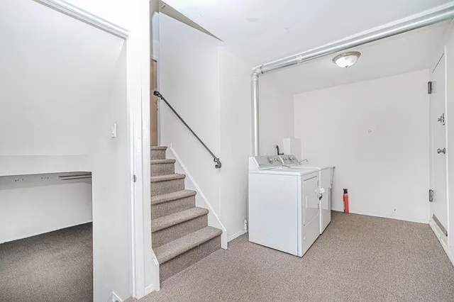 a view of a hallway to closet and utility room