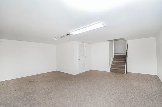 a view of an empty room with stairs