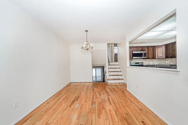 a view of a kitchen with a sink and microwave