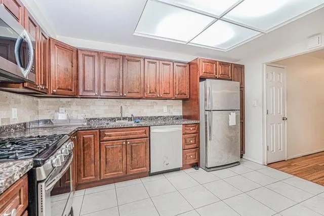 a kitchen with appliances cabinets and a counter top space