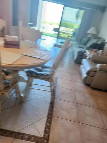 a living room with a couch and a chandelier