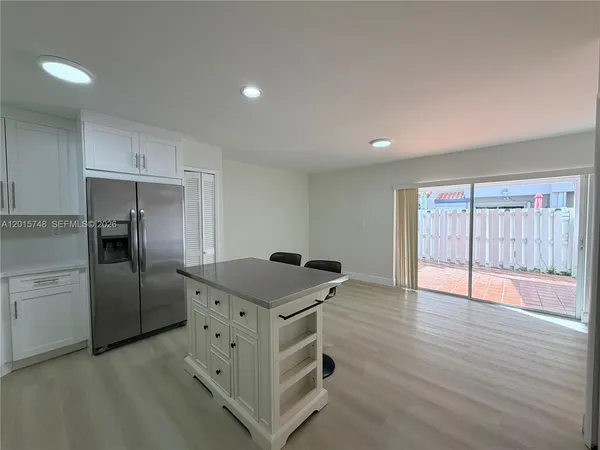 a kitchen with cabinets and wooden floor