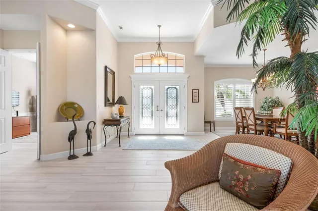 a view of a dining room with furniture wooden floor and a chandelier
