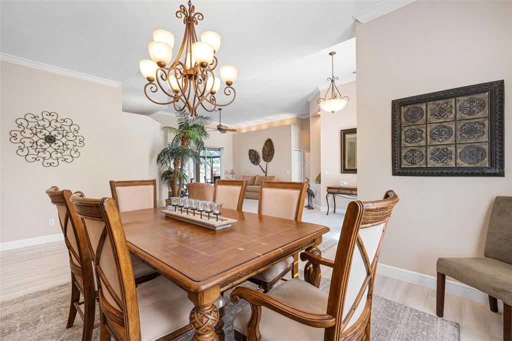 433 Tremingham Way Venice, FL 34293 - Photo 14 of 95 a view of a dining room with furniture and chandelier