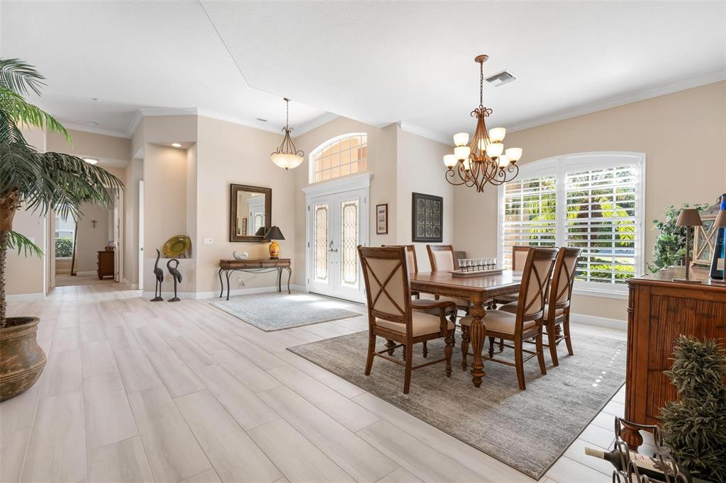433 Tremingham Way Venice, FL 34293 - Photo 15 of 95 a view of a dining room with furniture and a chandelier