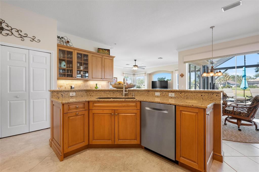 433 Tremingham Way Venice, FL 34293 - Photo 21 of 95 a kitchen with stainless steel appliances granite countertop a stove and more cabinets