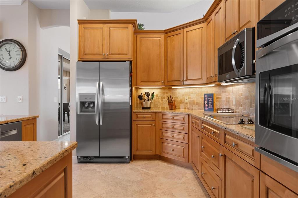 433 Tremingham Way Venice, FL 34293 - Photo 22 of 95 a kitchen with stainless steel appliances granite countertop a refrigerator a oven a sink and dishwasher