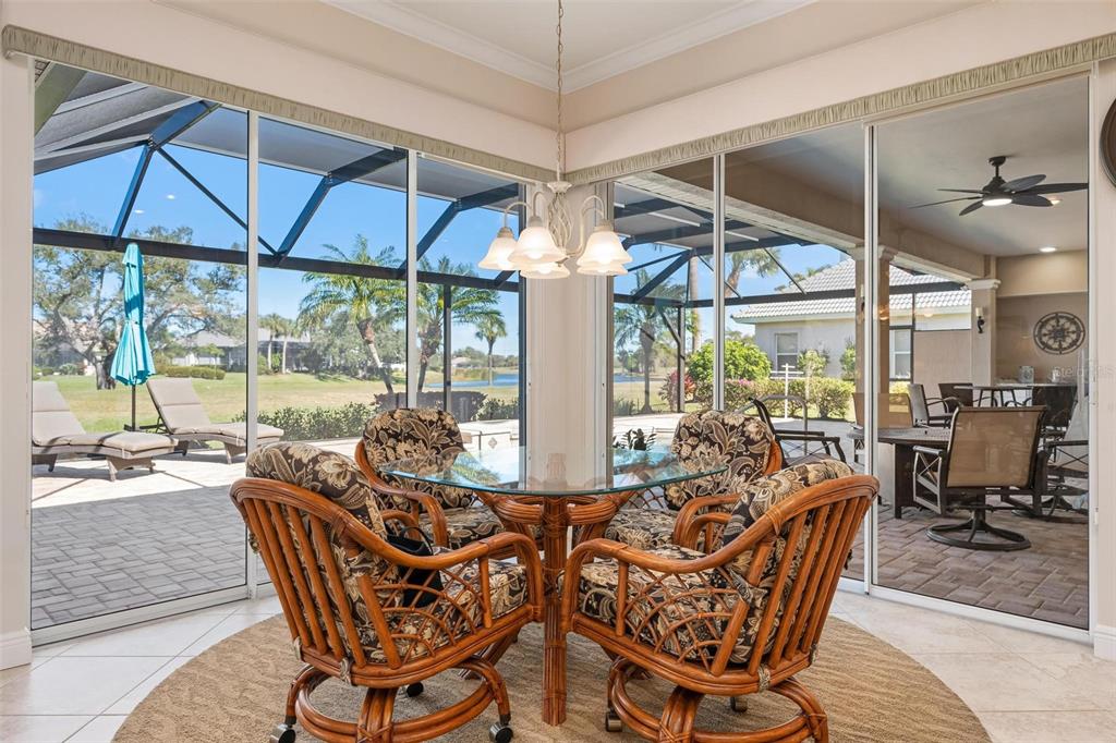 433 Tremingham Way Venice, FL 34293 - Photo 23 of 95 a view of a dining room with furniture wooden floor and a chandelier