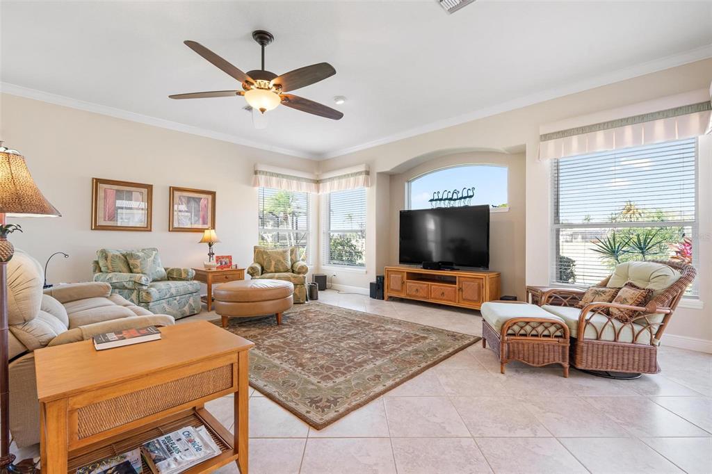 433 Tremingham Way Venice, FL 34293 - Photo 26 of 95 a living room with furniture and a flat screen tv