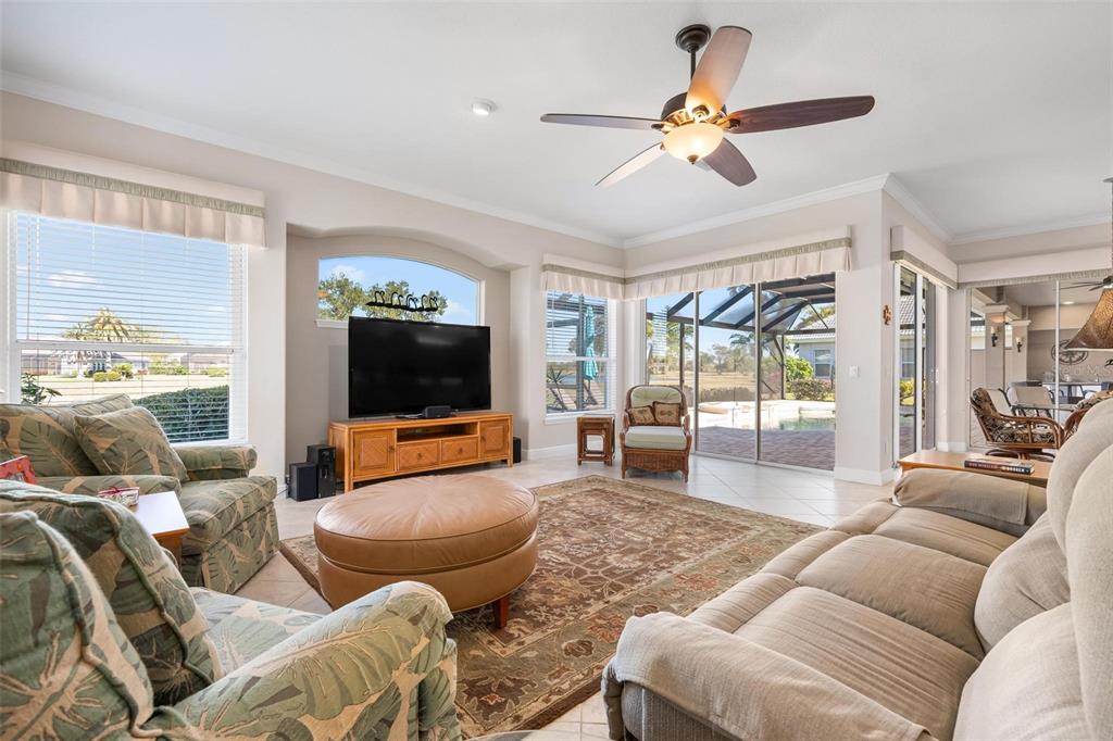 433 Tremingham Way Venice, FL 34293 - Photo 28 of 95 a living room with furniture and a flat screen tv
