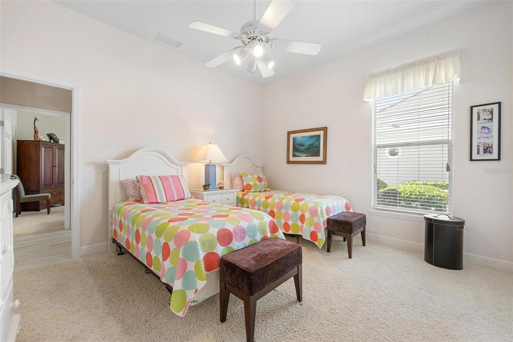 433 Tremingham Way Venice, FL 34293 - Photo 39 of 95 a bedroom with bed and a chandelier