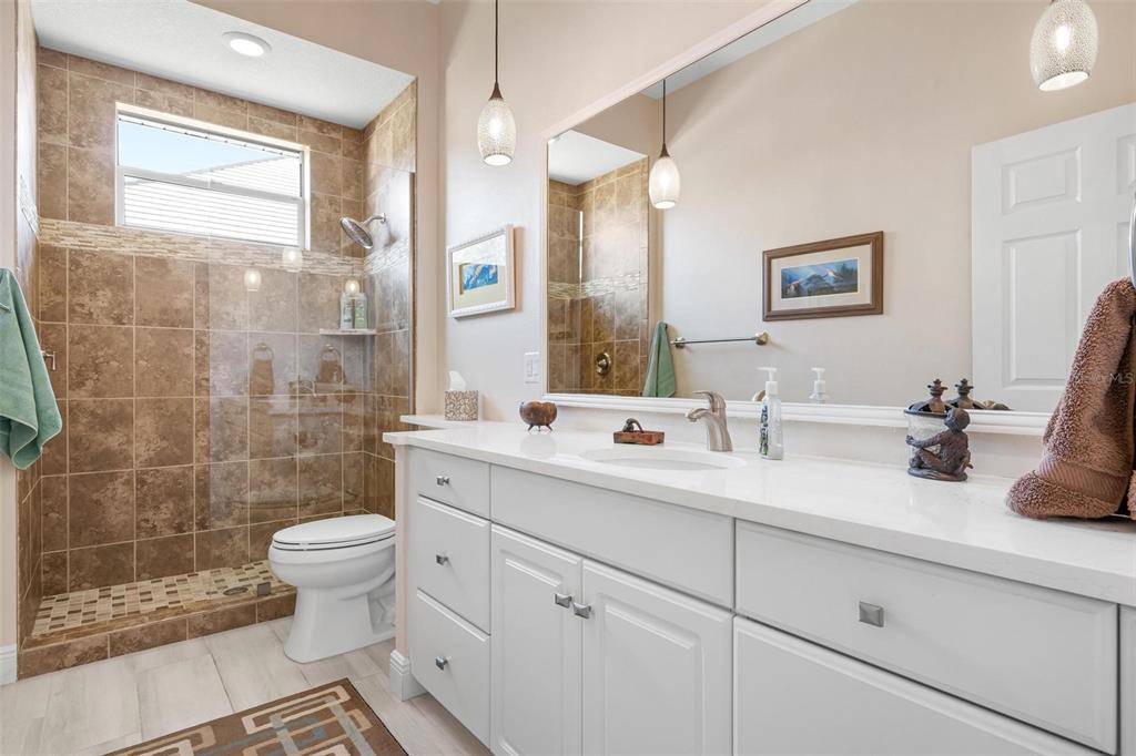 433 Tremingham Way Venice, FL 34293 - Photo 41 of 95 a bathroom with a sink toilet a mirror and shower