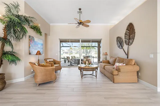 a view of a dining room with furniture a chandelier and wooden floor