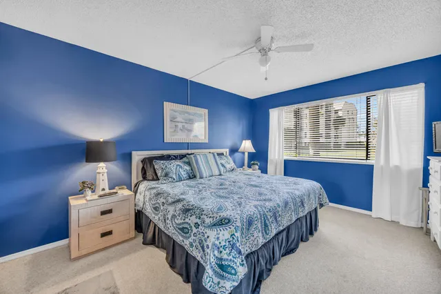 a spacious bedroom with a bed and a dresser