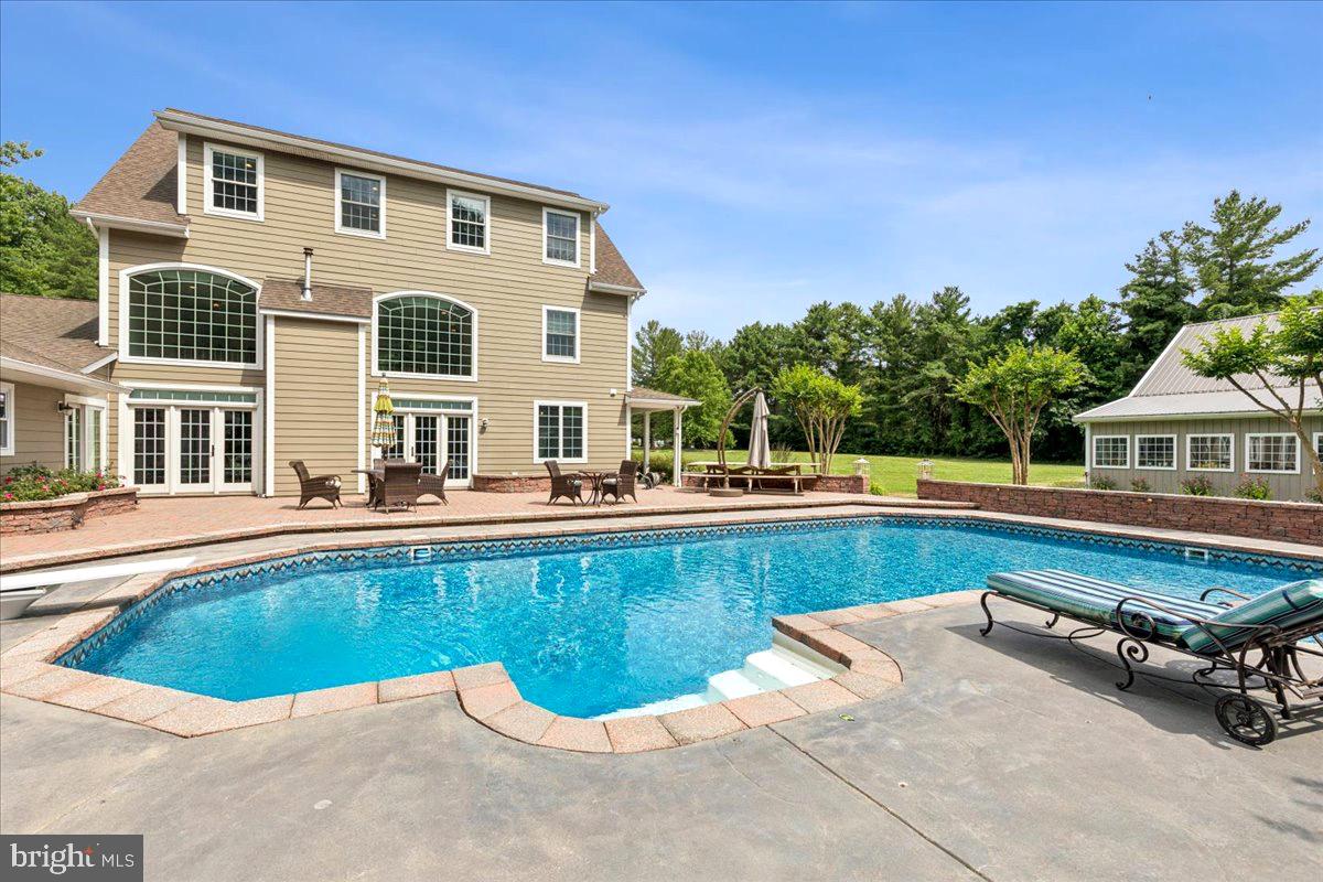 102 Little Neck Road Stevensville, MD 21666 - Photo 56 of 77 a swimming pool with outdoor seating and yard