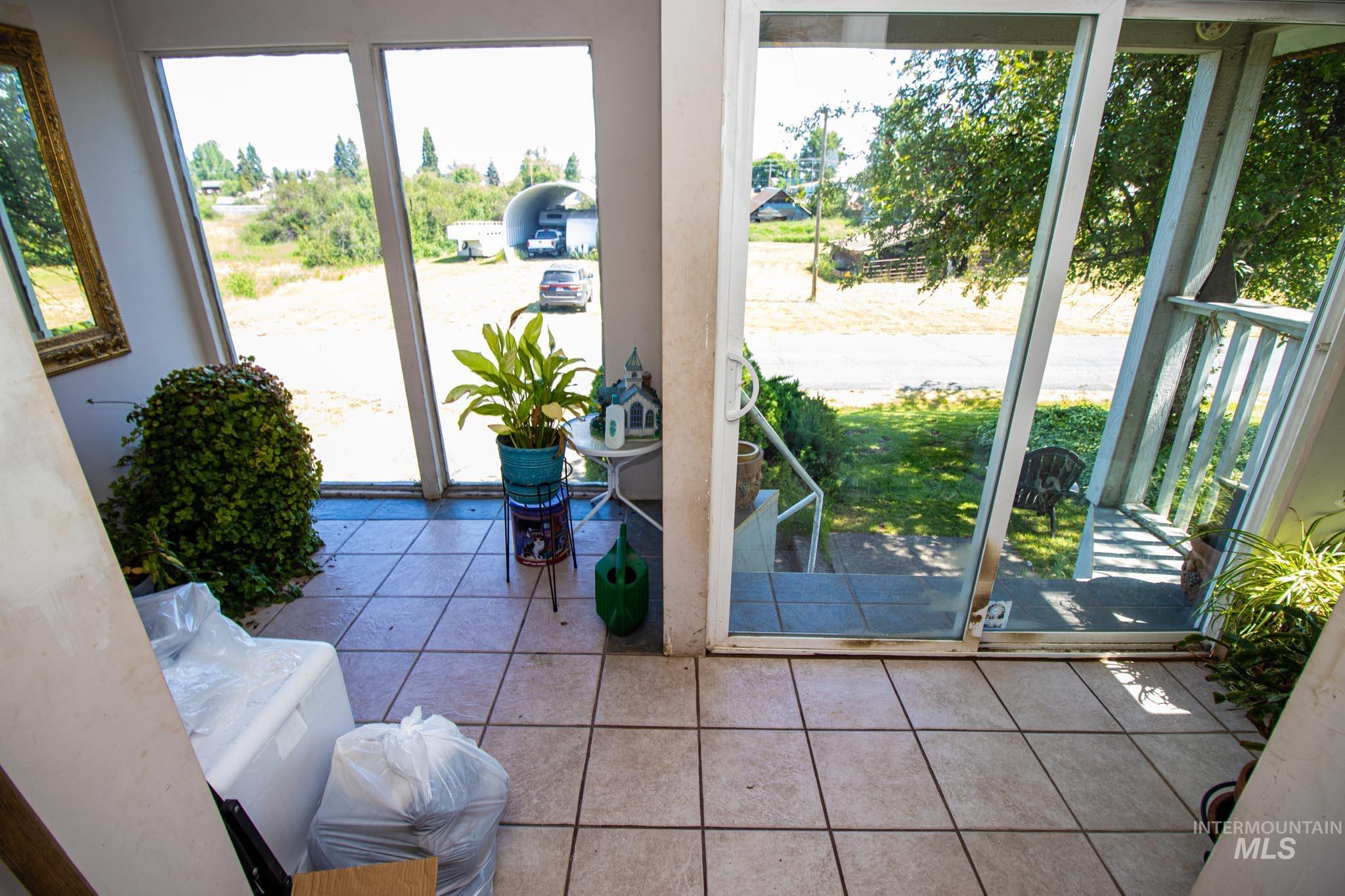 105 Weippe Avenue Weippe, ID 83553 - Photo 11 of 43 Doorway to outside featuring tile patterned flooring
