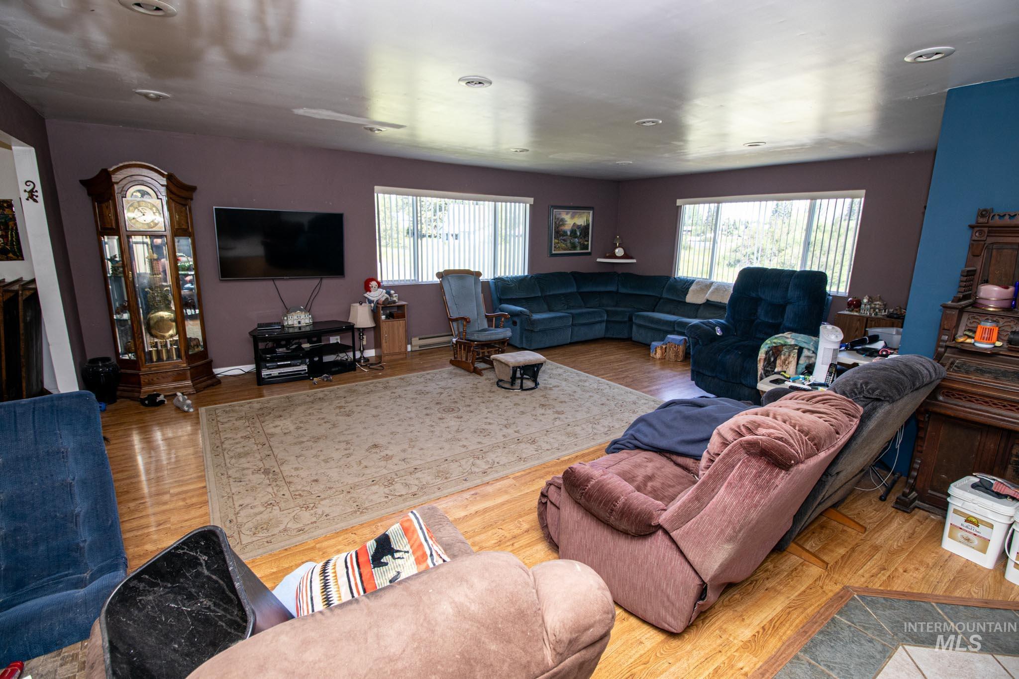 105 Weippe Avenue Weippe, ID 83553 - Photo 13 of 43 Living area with healthy amount of natural light and wood finished floors