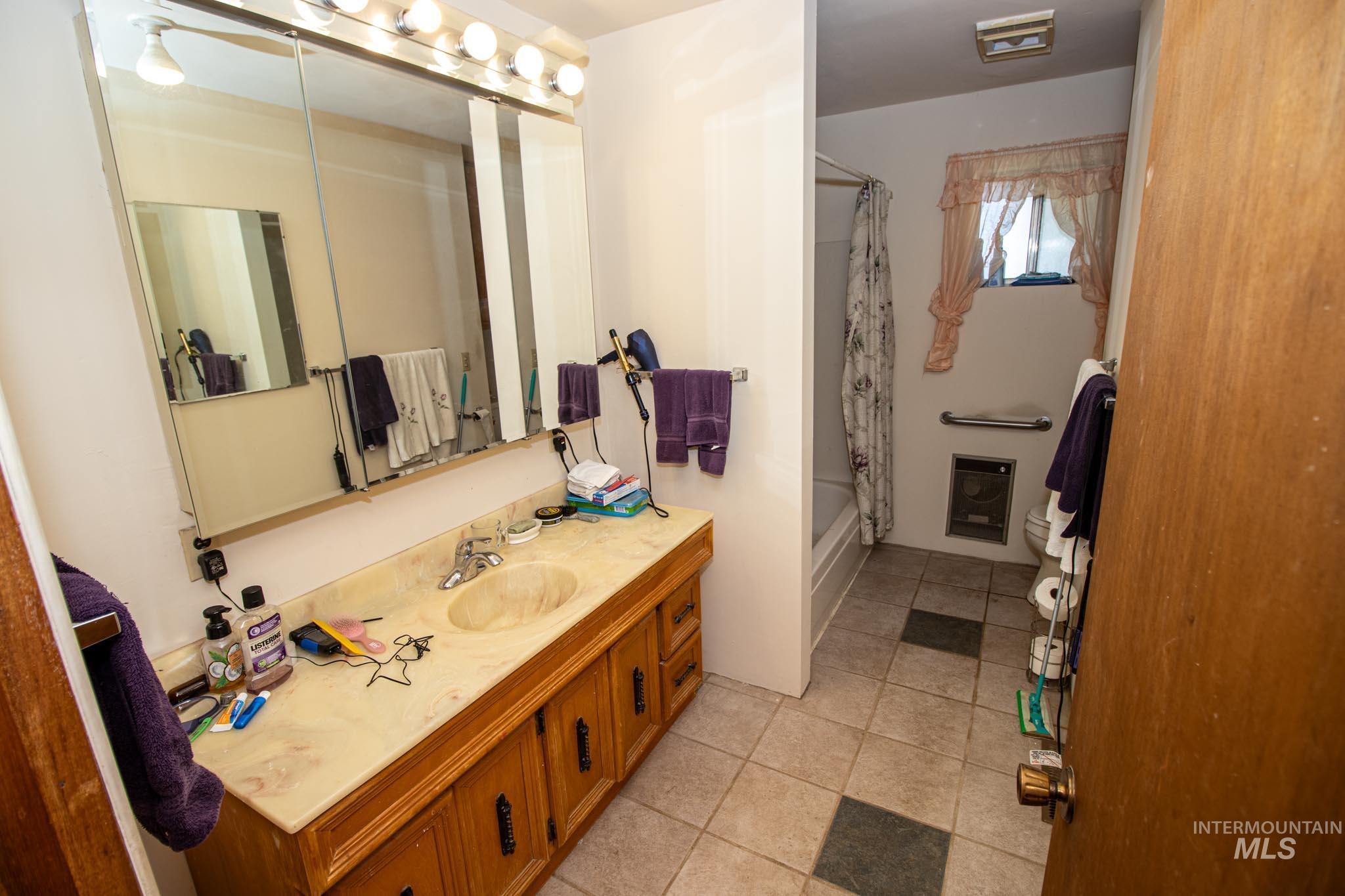 105 Weippe Avenue Weippe, ID 83553 - Photo 24 of 43 Bathroom featuring vanity, shower / tub combo, and tile patterned flooring