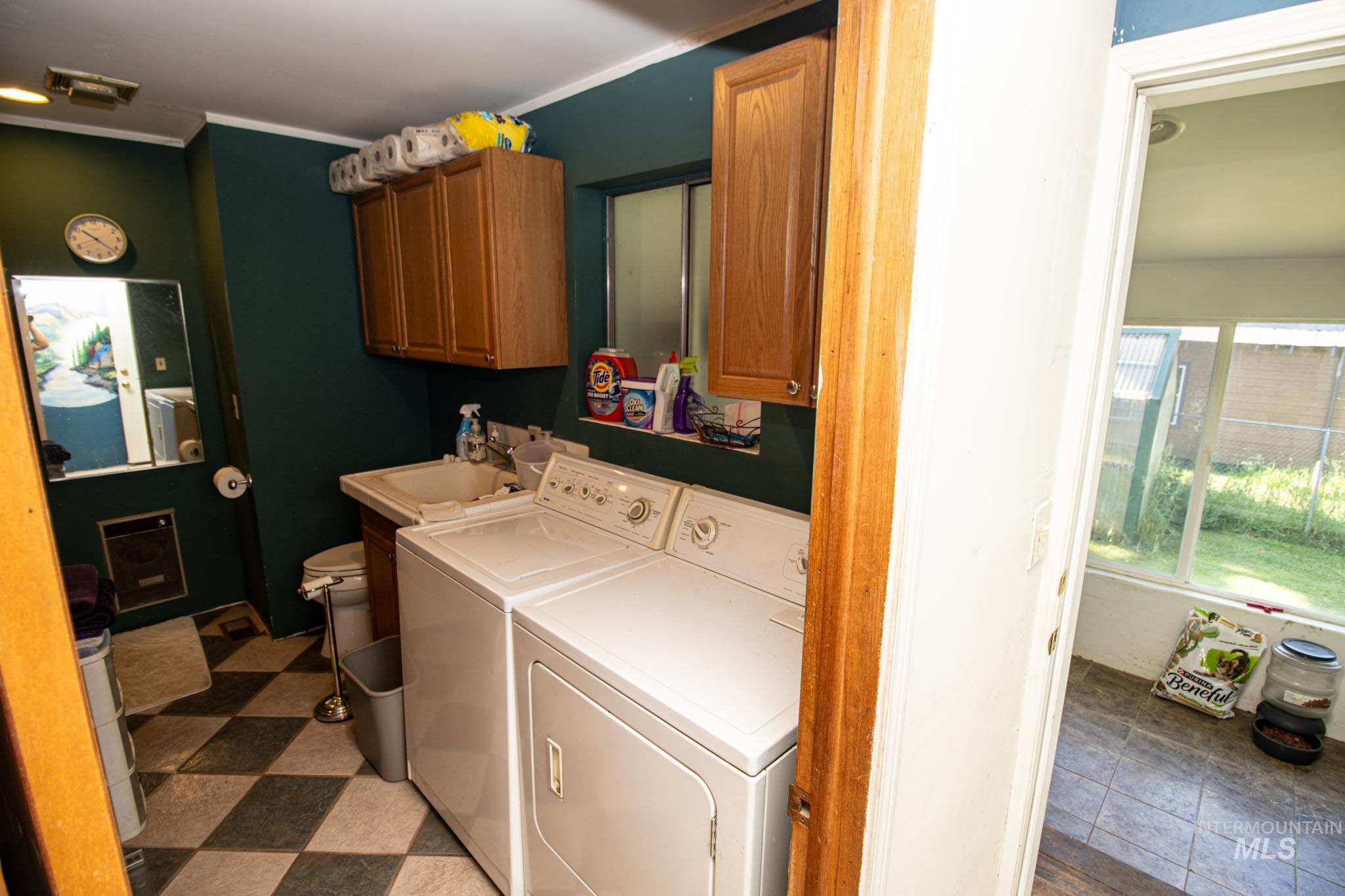 105 Weippe Avenue Weippe, ID 83553 - Photo 28 of 43 Laundry room featuring washing machine and dryer, cabinet space, and crown molding