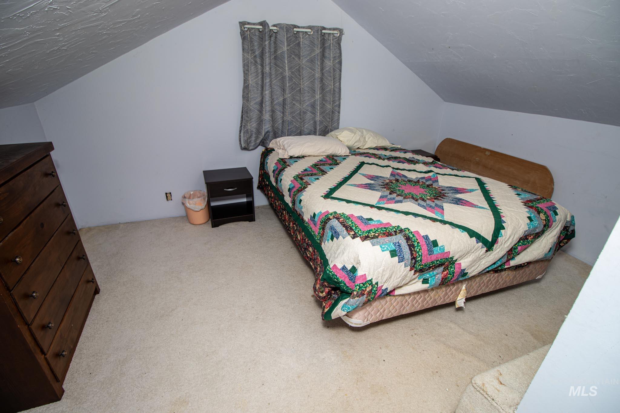105 Weippe Avenue Weippe, ID 83553 - Photo 32 of 43 Bedroom featuring carpet flooring and lofted ceiling