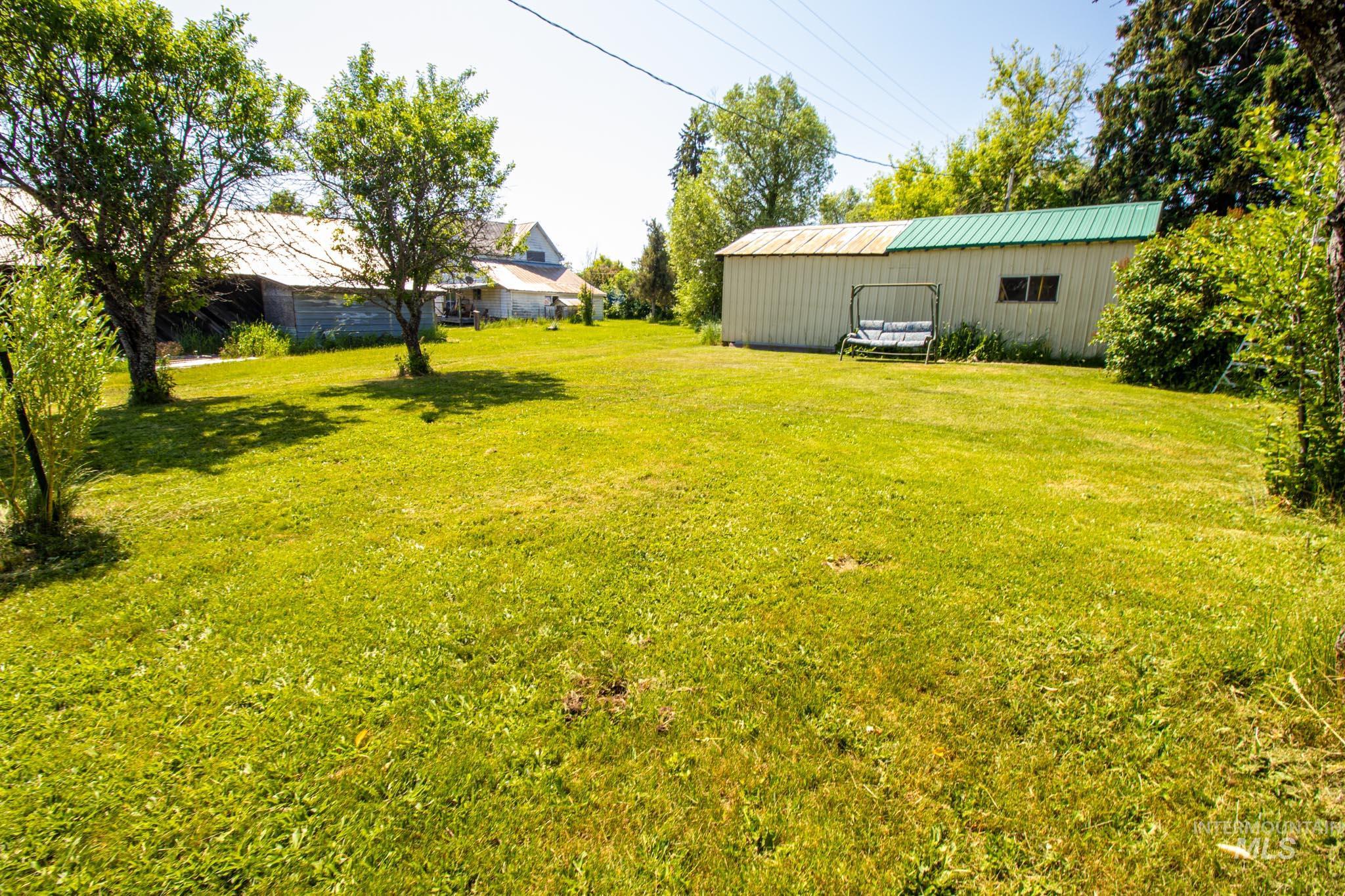 105 Weippe Avenue Weippe, ID 83553 - Photo 5 of 43 View of green lawn with a pole building and an outbuilding