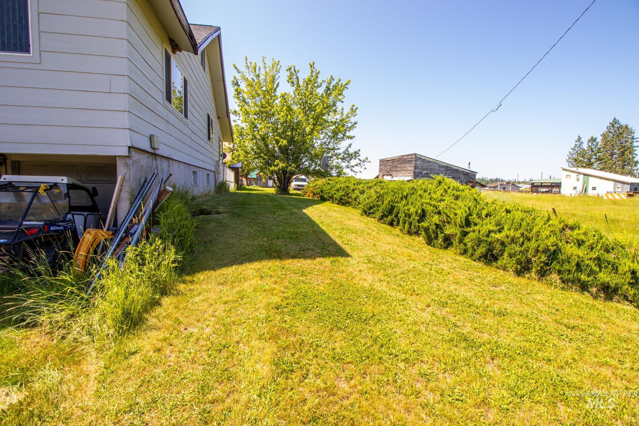 105 Weippe Avenue Weippe, ID 83553 - Photo 6 of 43 View of green lawn featuring a garage