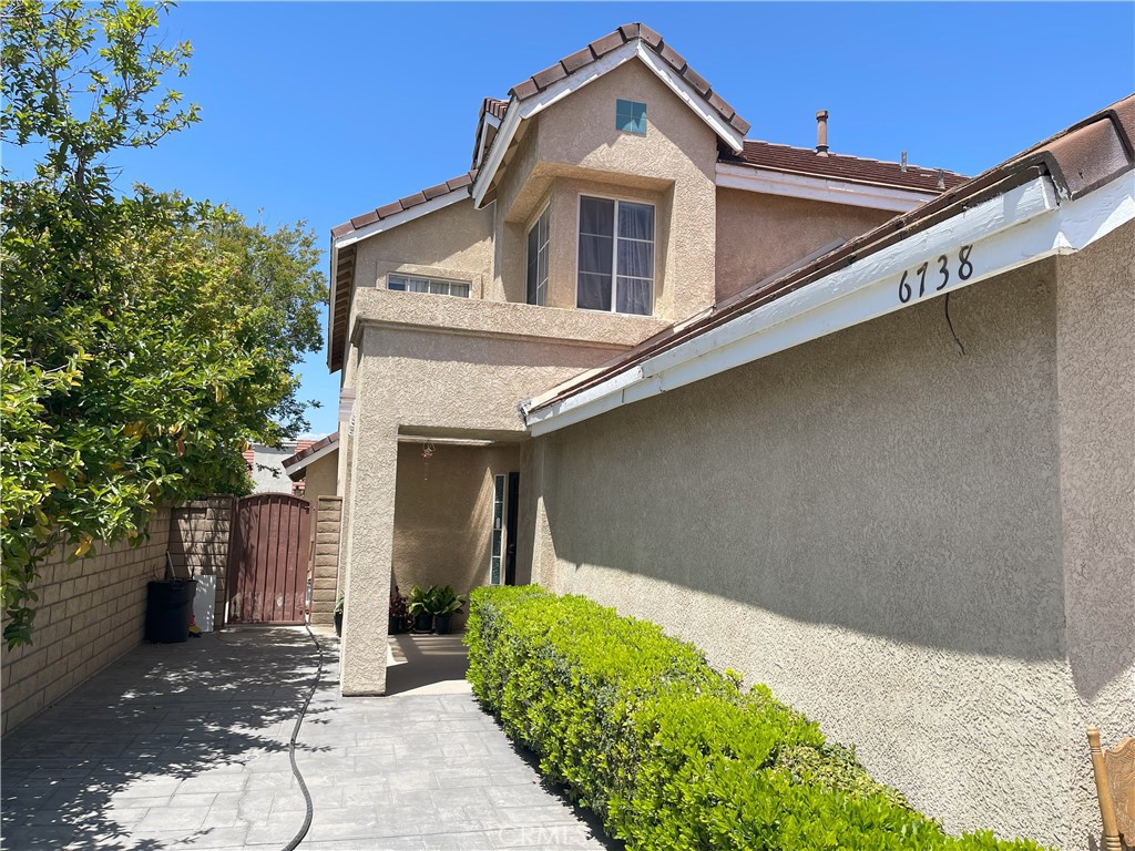 6738 Wrangler Road Chino Hills, CA 91709 - Photo 3 of 4 a front view of a house with garden