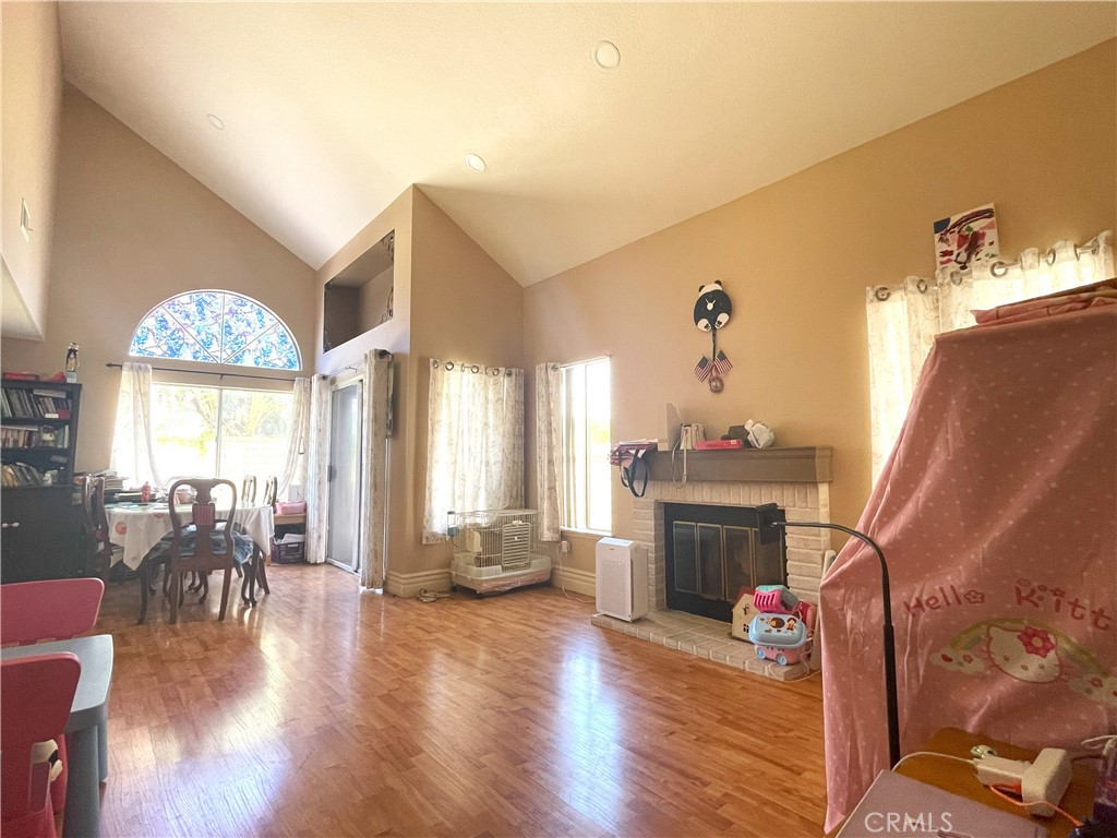 6738 Wrangler Road Chino Hills, CA 91709 - Photo 4 of 4 a living room with furniture a fireplace and wooden floor
