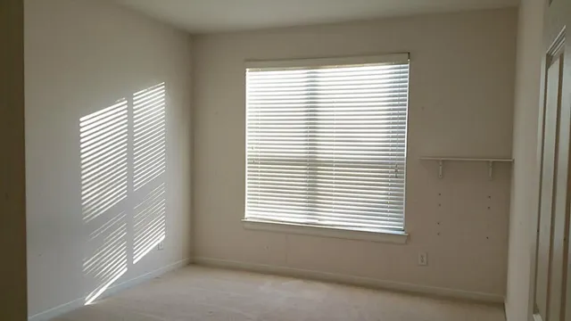 a bathroom with a sink a toilet a mirror and shower