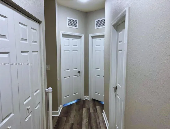 a view of bedroom with wooden floor