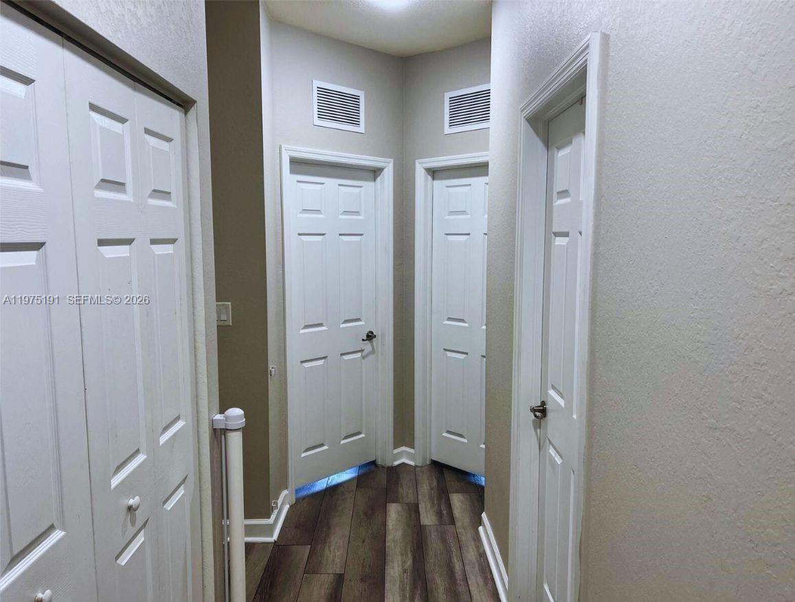 15076 Southwest 117th Terrace Miami, FL 33196 - Photo 13 of 31 a view of a hallway with closet and a livingroom