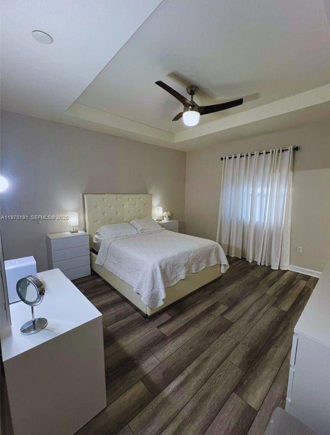 15076 Southwest 117th Terrace Miami, FL 33196 - Photo 18 of 31 a bedroom with double bed and a chandelier