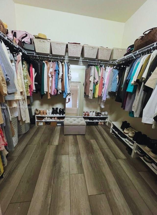 15076 Southwest 117th Terrace Miami, FL 33196 - Photo 19 of 31 a view of walk in closet with clothes and shoes