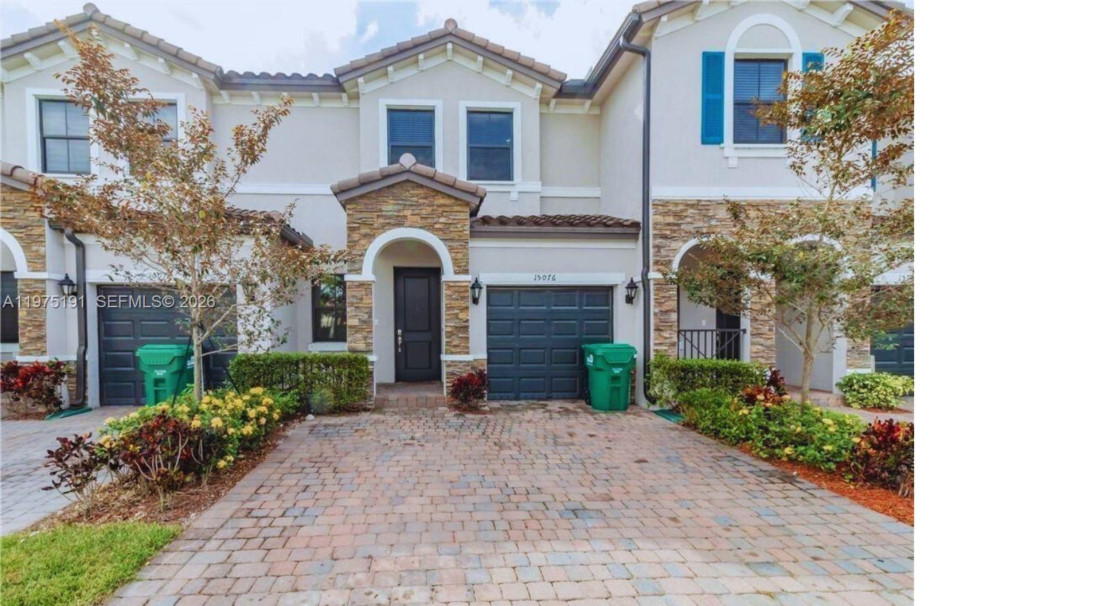 15076 Southwest 117th Terrace Miami, FL 33196 - Photo 2 of 31 a front view of a house with a garden