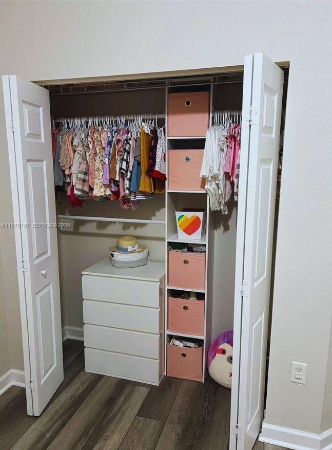 15076 Southwest 117th Terrace Miami, FL 33196 - Photo 21 of 31 a view of walk in closet with clothes and shoes