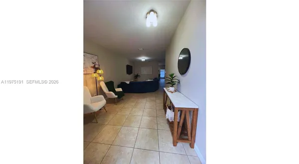 a lobby with a couch and a potted plant