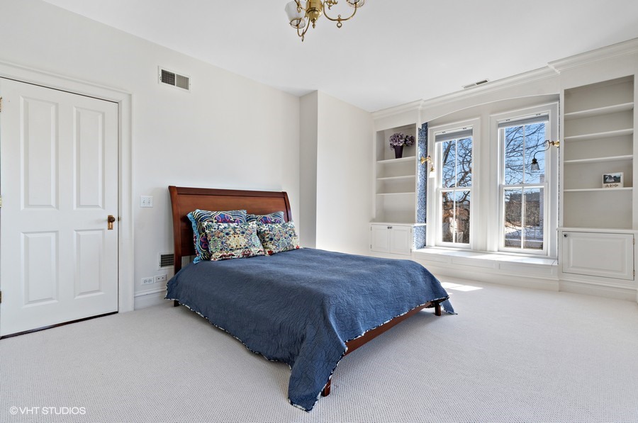 750 Glencoe Drive Glencoe, IL 60022 - Photo 13 of 26 a spacious bedroom with a bed and a window