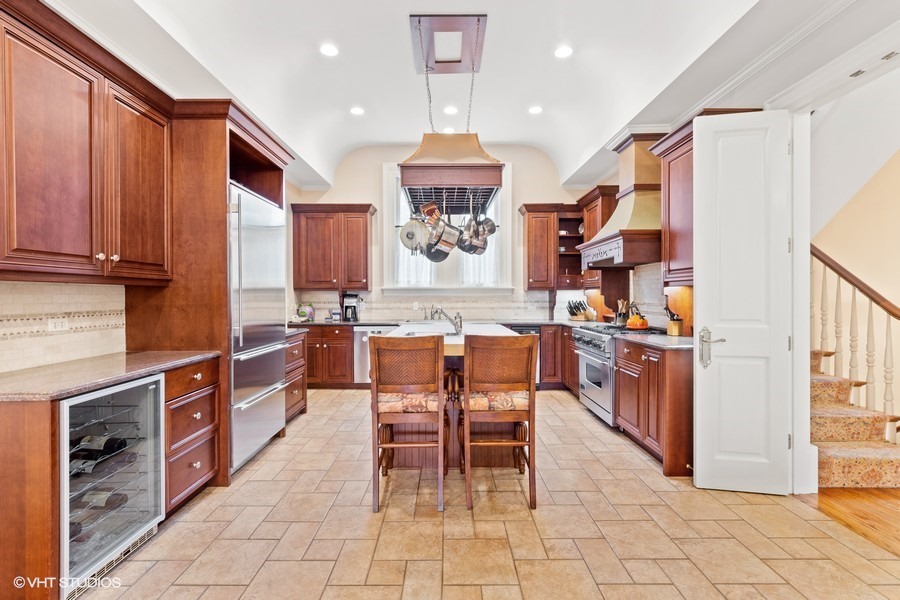 750 Glencoe Drive Glencoe, IL 60022 - Photo 7 of 26 a view of a hallway with a dining table and chandelier