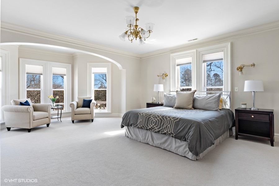 750 Glencoe Drive Glencoe, IL 60022 - Photo 10 of 26 a spacious bedroom with a bed and a chandelier