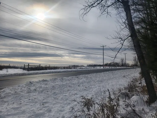 a view of a yard with wooden fence