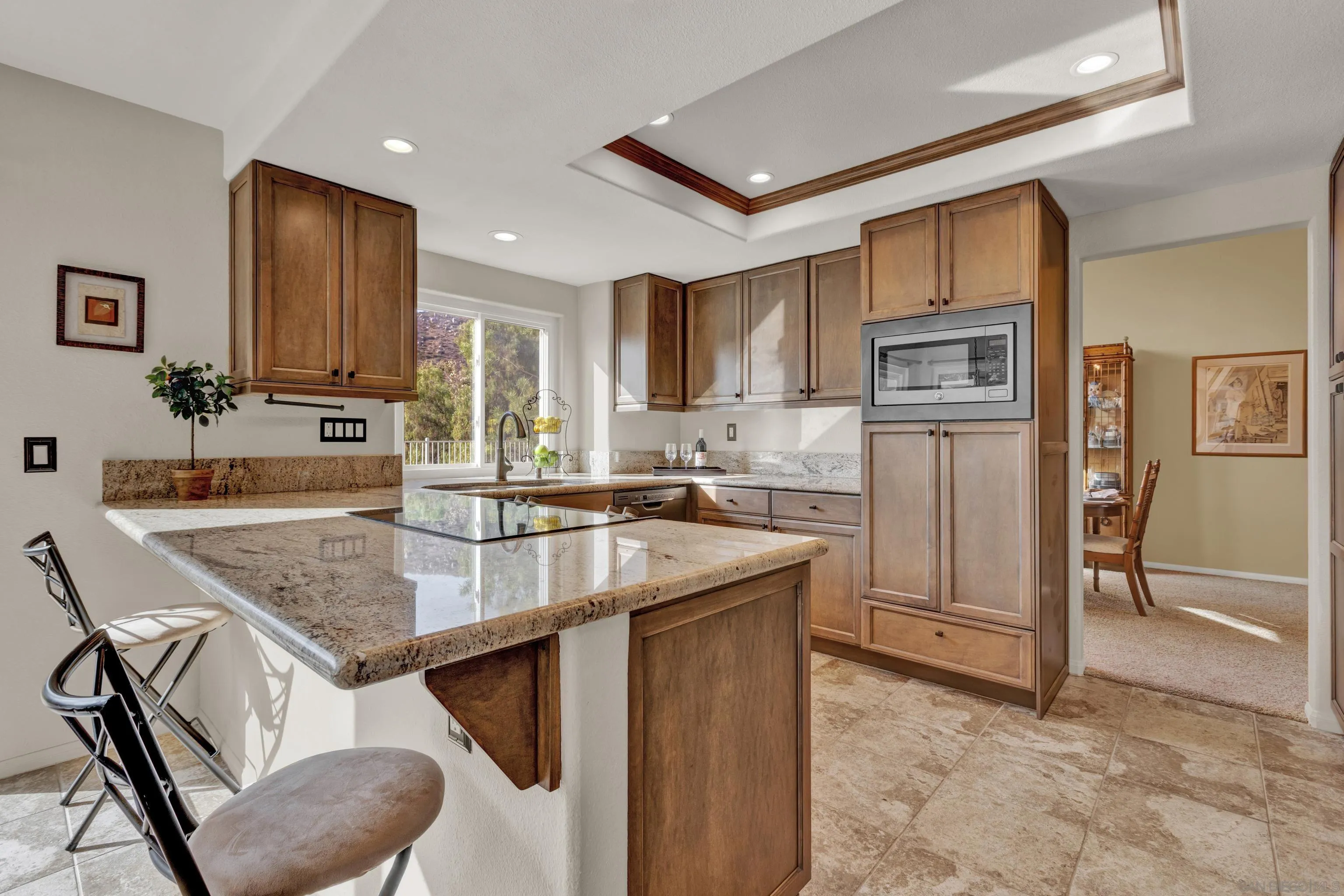 15550 Garden Road Poway, CA 92064 - Photo 12 of 48 a kitchen with stainless steel appliances granite countertop a table chairs sink and cabinets