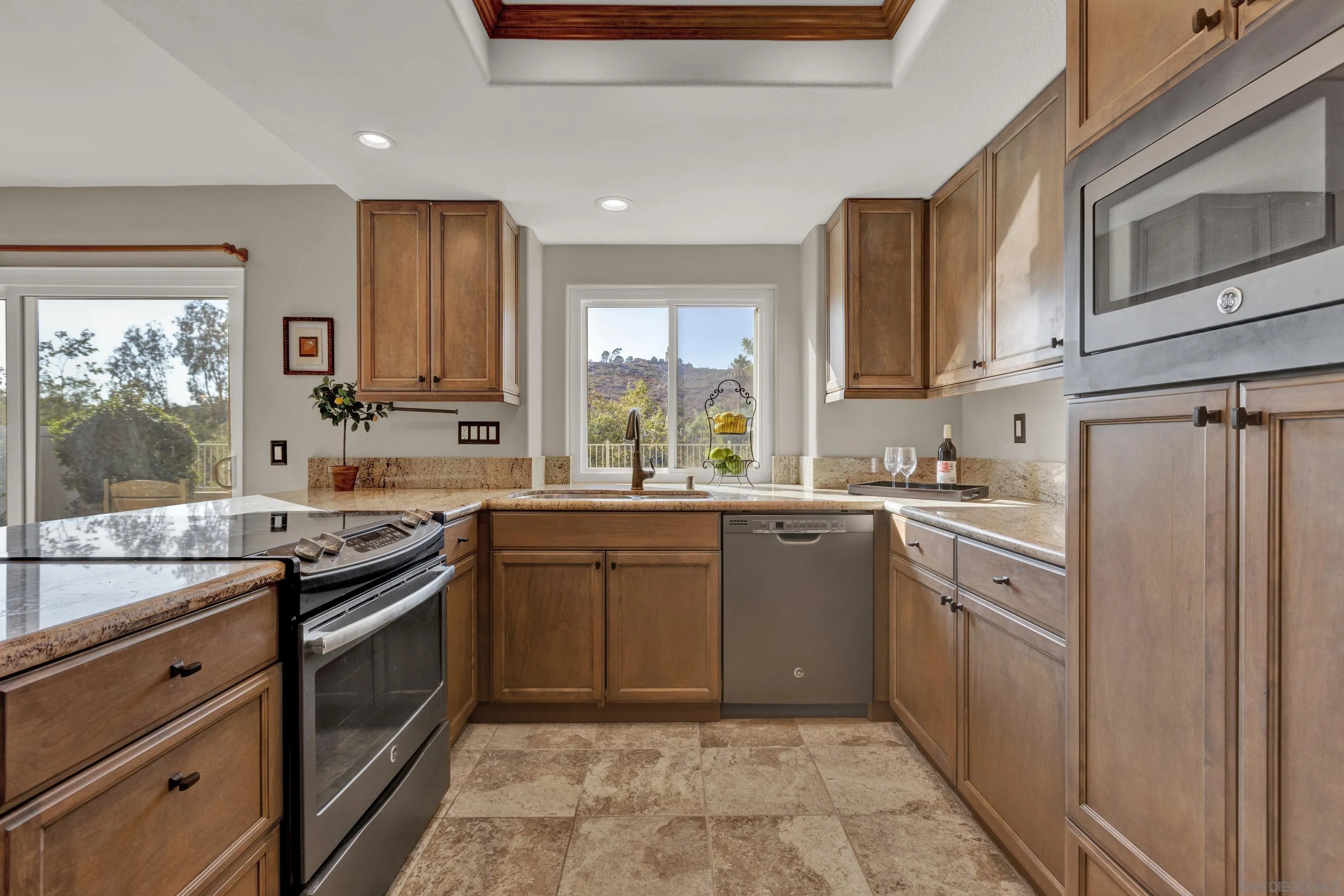 15550 Garden Road Poway, CA 92064 - Photo 14 of 48 a kitchen with stainless steel appliances granite countertop a stove sink and cabinets