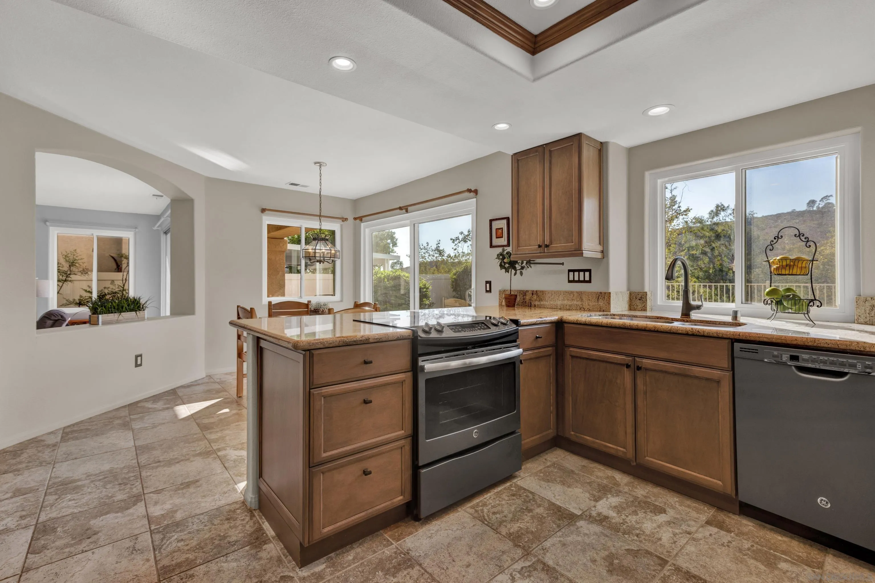 15550 Garden Road Poway, CA 92064 - Photo 15 of 48 a kitchen with stainless steel appliances granite countertop a stove a sink and a refrigerator
