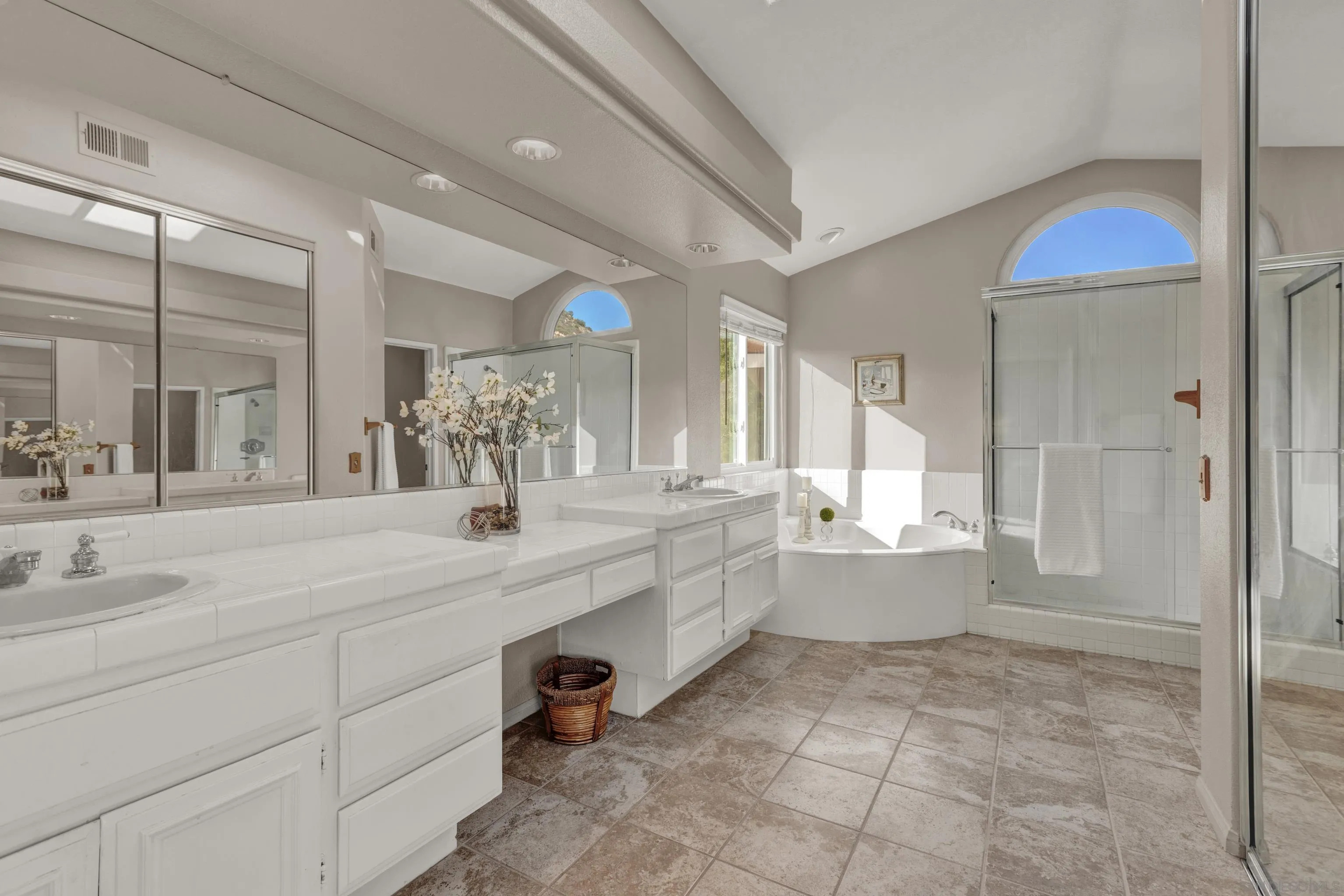15550 Garden Road Poway, CA 92064 - Photo 28 of 48 a large bathroom with a double vanity sink a mirror and a bathtub