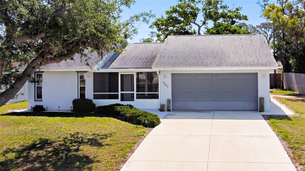 985 Everest Road Venice, FL 34293 - Photo 1 of 1 a front view of a house with a yard and potted plants