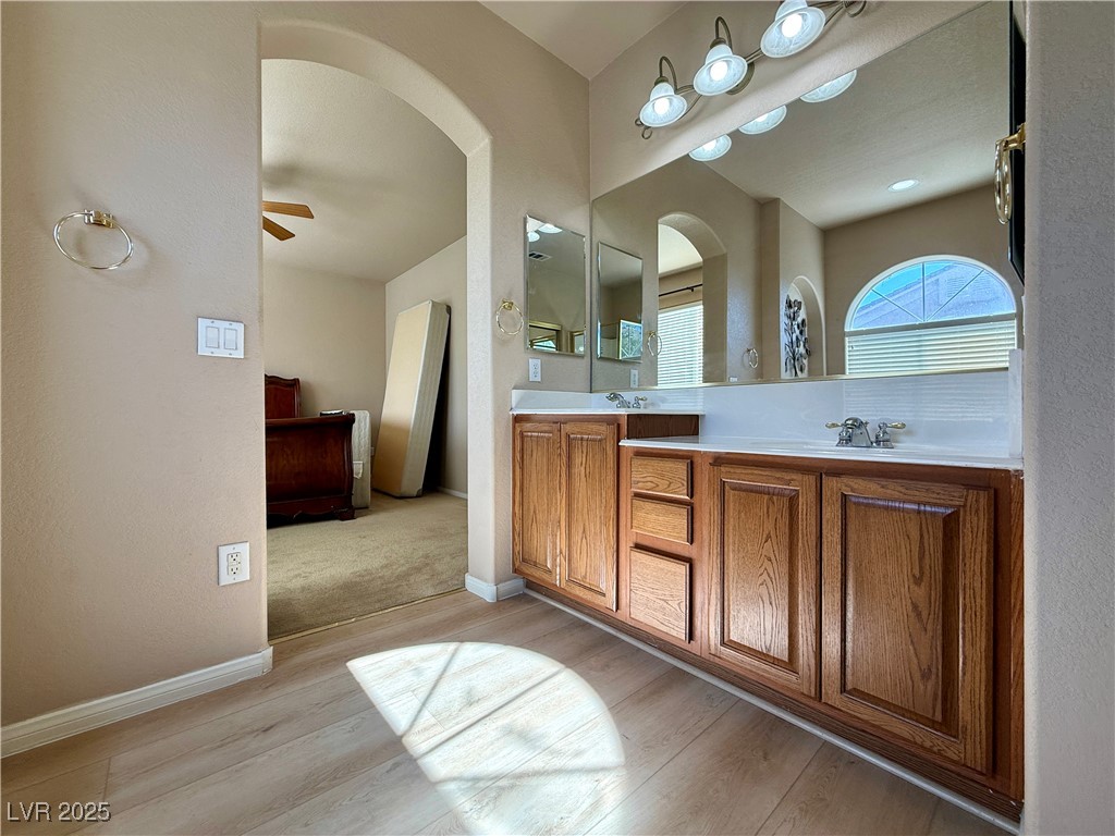 6031 Lamotte Avenue Las Vegas, NV 89141 - Photo 15 of 28 Full bathroom with double vanity, light wood-type flooring, and ceiling fan