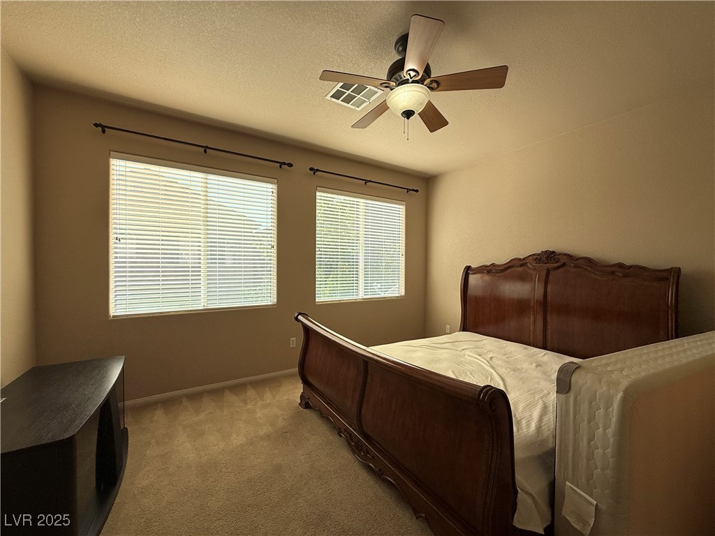 6031 Lamotte Avenue Las Vegas, NV 89141 - Photo 17 of 28 Carpeted bedroom featuring a textured ceiling and ceiling fan