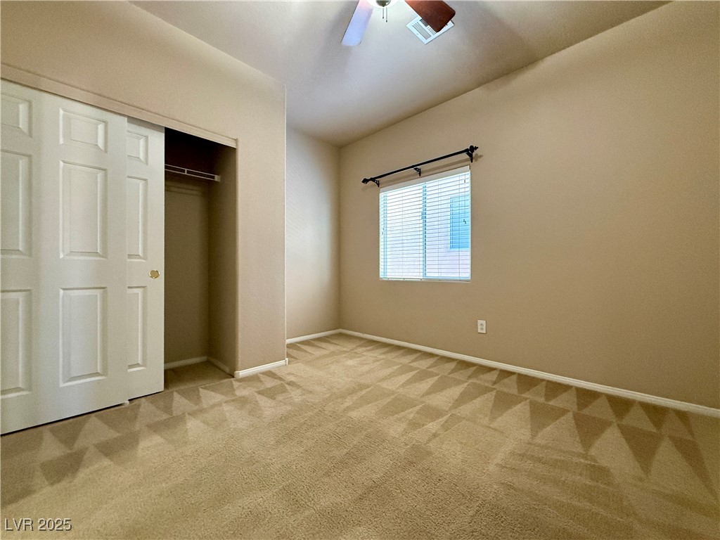 6031 Lamotte Avenue Las Vegas, NV 89141 - Photo 22 of 28 Unfurnished bedroom with light colored carpet, a closet, and ceiling fan