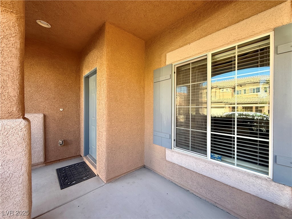 6031 Lamotte Avenue Las Vegas, NV 89141 - Photo 4 of 28 View of exterior entry with stucco siding