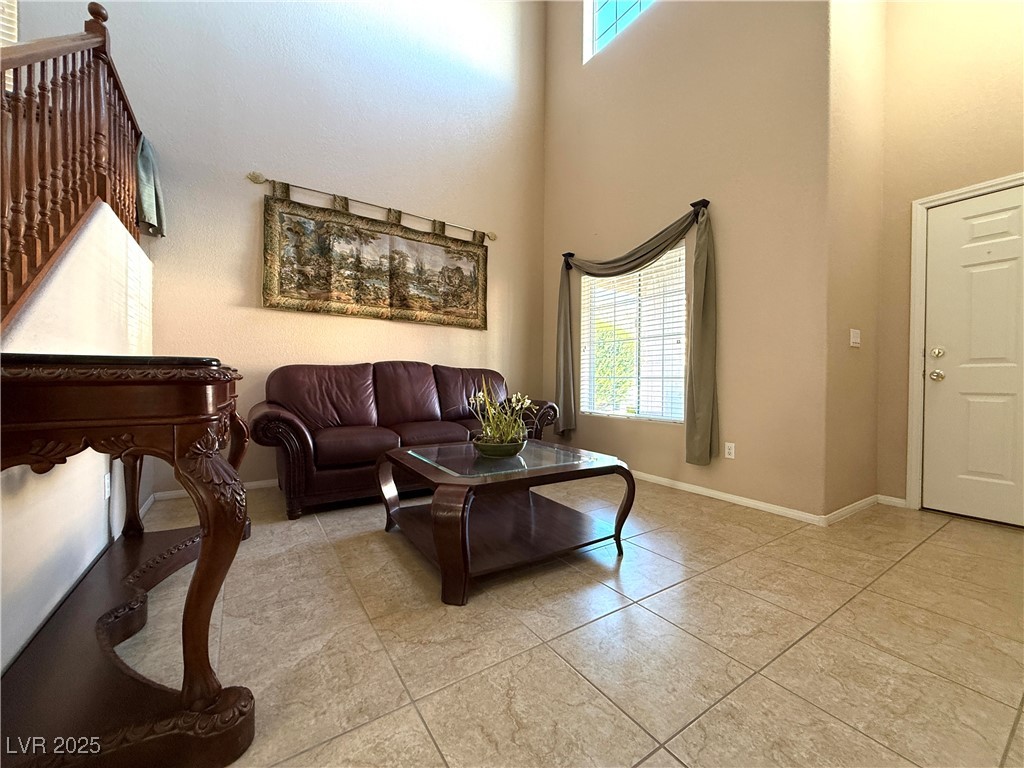 6031 Lamotte Avenue Las Vegas, NV 89141 - Photo 6 of 28 Living area with a high ceiling and light tile patterned floors